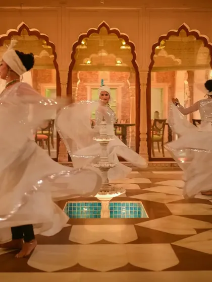 Kathak dancers perform in the central courtyard of Haveli Dharampura. The architecture was intentionally designed to serve as a stage for cultural events, allowing guests on all floors to witness and appreciate these timeless traditions.