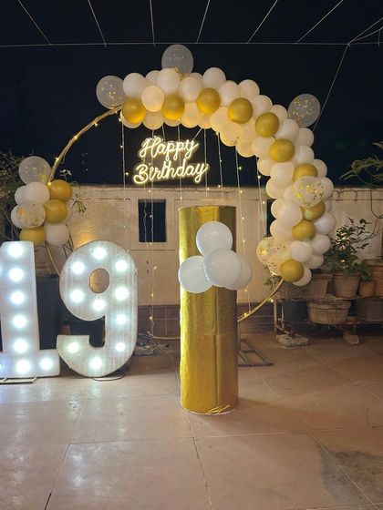 A closer look at the elegant 19th birthday balloon arch and light-up numbers.
