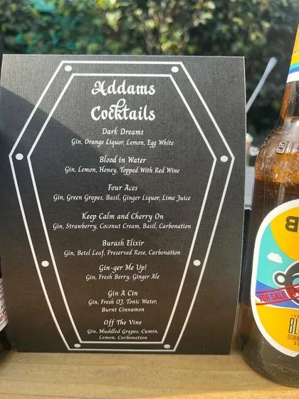 A spooky and stylish Addams Family themed cocktail menu for a unique "Wednesday" birthday party.