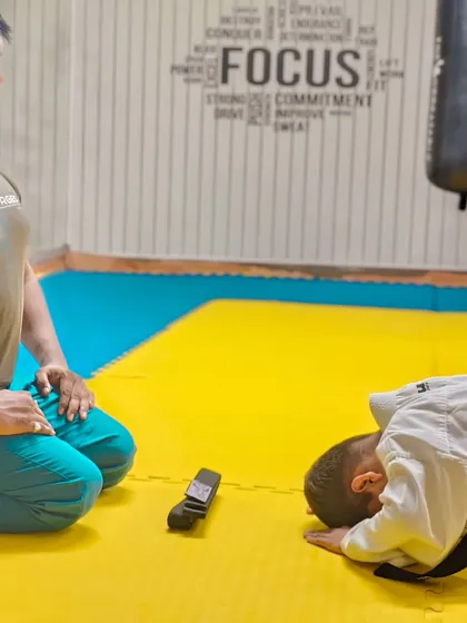 The traditional bow after receiving a new belt, a sign of humility and respect for the art and the teacher.