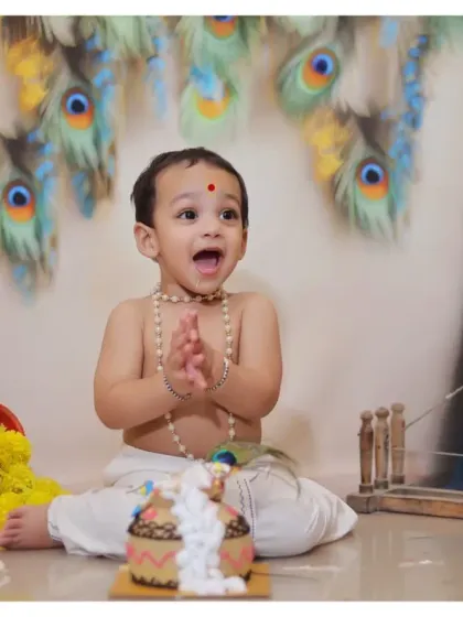 Celebrating a milestone with a Krishna-themed cake smash. This unique concept combines the fun of a birthday with the beauty of cultural tradition, complete with a 'dahi handi' style cake.