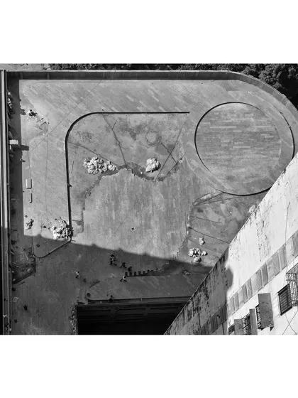 An aerial view during the early construction phase of a large-scale podium project. This perspective shows the foundational layout of the pathways and a central circular feature taking shape, demonstrating how our detailed site-responsive planning translates to the ground.