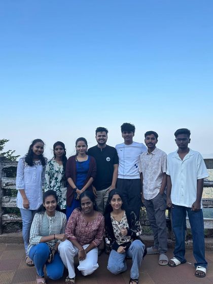 A group photo at a viewpoint in Agumbe, overlooking the hills during our coastal trip.