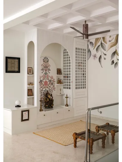 I design serene and spiritual spaces like this custom puja unit. It blends modern aesthetics with timeless tradition, featuring delicate arches, intricate jali latticework, and integrated storage to create a peaceful sanctuary in your home.