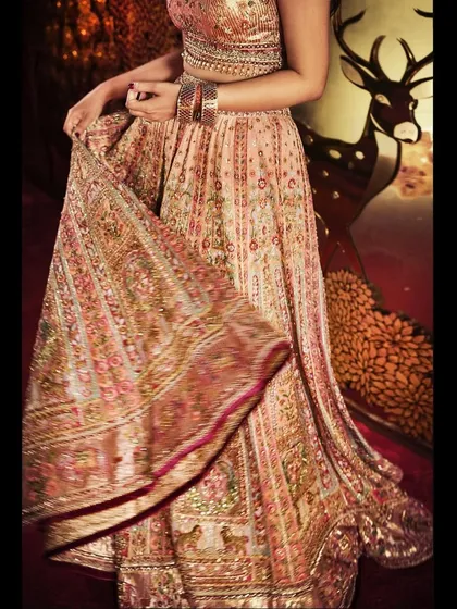 A detail shot showing the movement and flow of the Tarun Tahiliani lehenga skirt. The craftsmanship is evident in every layer of fabric and embroidery.