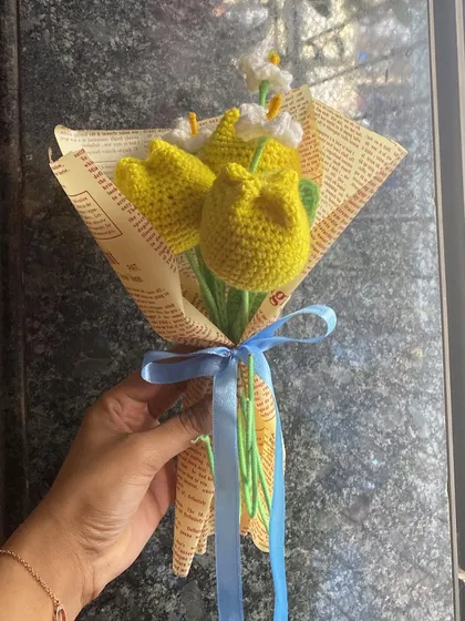 A still image of the yellow tulip bouquet, showing the lovely contrast between the bright flowers and the rustic newspaper wrap.