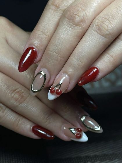 A playful and chic design with 3D cherries and gold chrome outlines. This is a great example of how to incorporate fun, trendy elements into your nail art services.