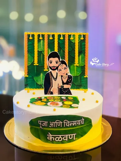 I love creating cakes that celebrate our beautiful Maharashtrian traditions. This one was for a 'Kelvan' ceremony, a special pre-wedding ritual. It features custom caricatures of the couple and traditional motifs like banana leaves and marigold flowers.