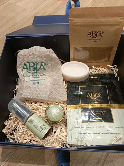 A look inside one of my corporate gift boxes, featuring a mini facial kit, hair oil, bath powder, and a bamboo sheet mask.
