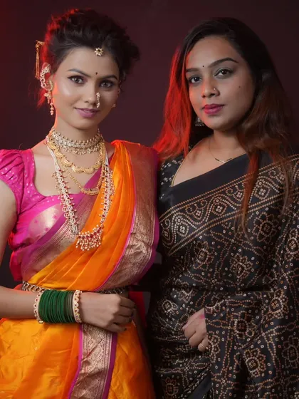 This student created a stunning Maharashtrian bridal look with a vibrant orange and pink saree.
