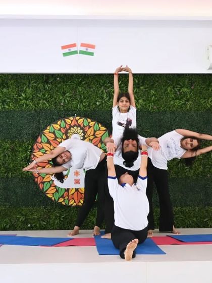 A creative and playful group pose from one of our yoga demonstrations. This shows the fun, trust, and teamwork that we foster within our Divine Soul Yoga family.