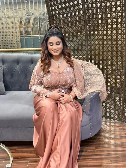 A smiling shot of the client, looking radiant and ready for her event. The makeup is designed to enhance her natural beauty and provide a polished finish.