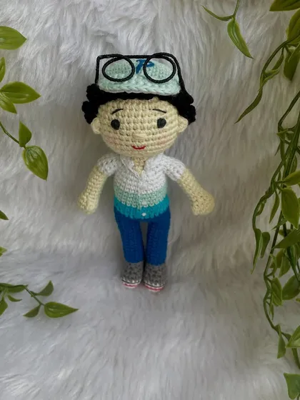 This handsome little boy replica doll features curly hair, a cap, and removable glasses. It’s so fun to create these little details that make each doll a true mini-me.