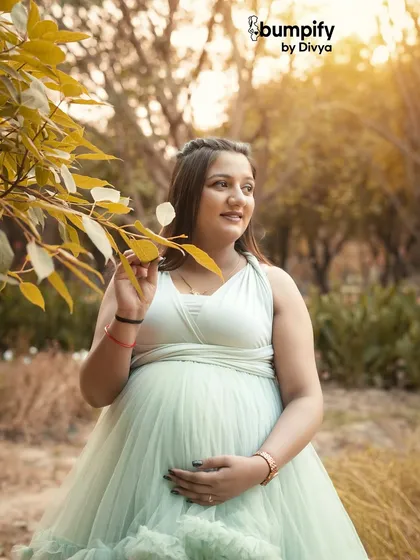 A close-up portrait capturing the soft light and the gentle expression of the mom-to-be. The golden hour glow makes these outdoor maternity photos extra special.