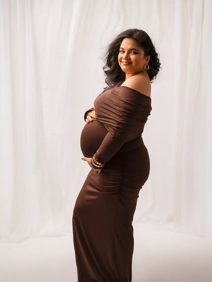 A simple, smiling portrait against a clean white backdrop. Sometimes, your joy is the only accessory you need.