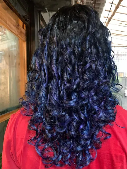 The back of this blue and purple curly hair. The colors are so vibrant and the curls are perfectly defined.