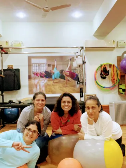 Just a few of the smiling faces you'll find at the studio. We use stability balls and other props to keep our workouts varied and engaging.