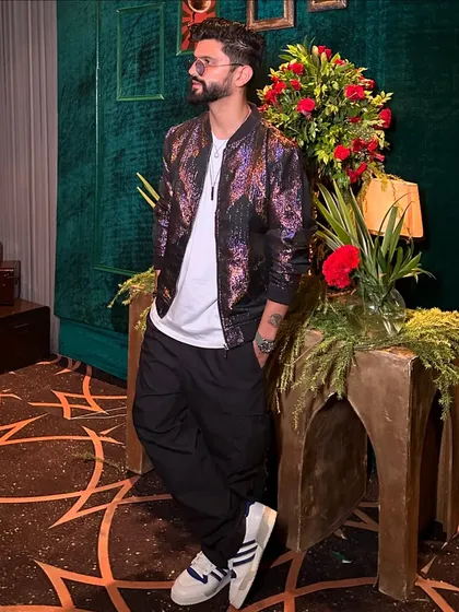 The same bomber jacket look in color, showing off the cool, iridescent pattern of the jacket.
