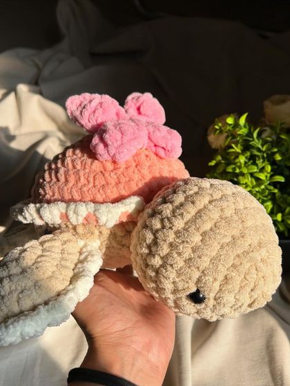 Holding our large butterfly turtle. It's the perfect size for a big hug and makes a beautiful statement piece in a nursery.