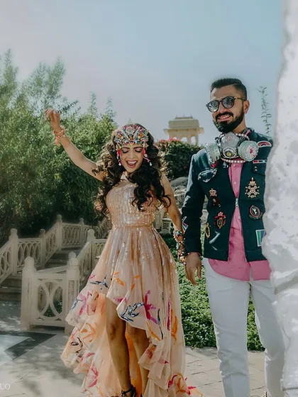 Another angle of the couple's festive entrance, showcasing their unique, avant-garde outfits that perfectly matched the event's theme.