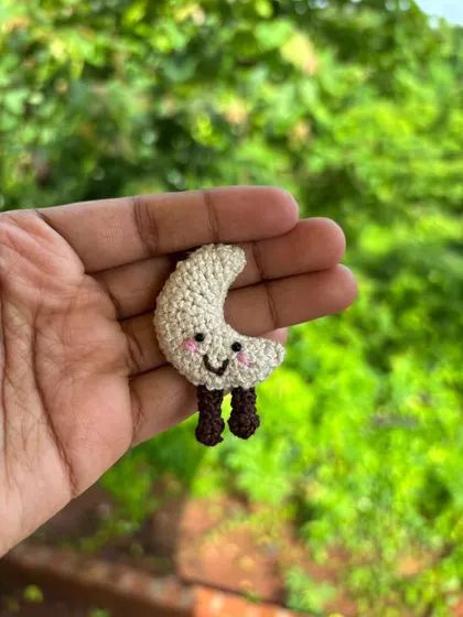 A solo shot of the sweet moon keychain. It's a perfect reminder of a calming presence in your life.