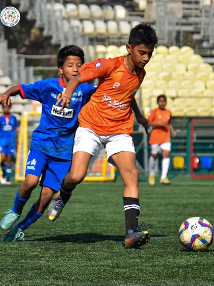 A player shows great balance and control while dribbling. Technical proficiency is a cornerstone of our training philosophy.