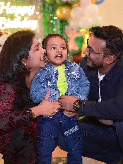 A heartwarming photo of a mother and father with their little one. These tender moments are what make a celebration truly special.