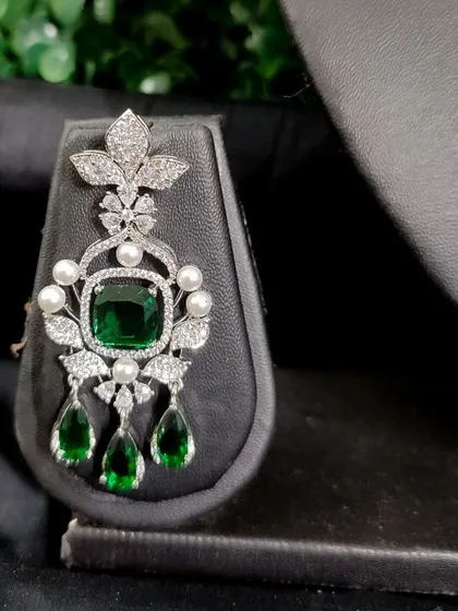 The matching earring for this set, perfect for adding a touch of glamour.
