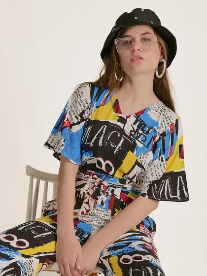 A seated pose that conveys a cool, confident attitude, perfectly matching the style of the graphic-heavy apparel.