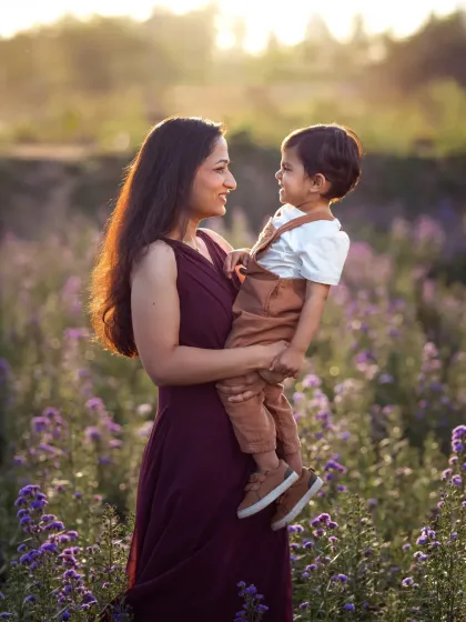 A field of flowers is the perfect setting for a dreamy mother-and-child portrait. The way the light catches them, the shared glance, it all comes together to create a truly poetic image.