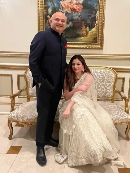 A suit that speaks for itself. My client, pictured with his wife, wears a custom navy bandhgala, crafted with precision for a look of timeless elegance.