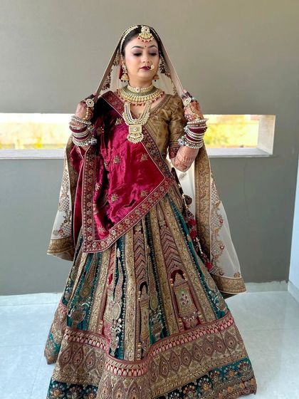 A beautiful shot of a bride adjusting her dupatta. The makeup is soft and elegant, designed to look stunning in natural light.