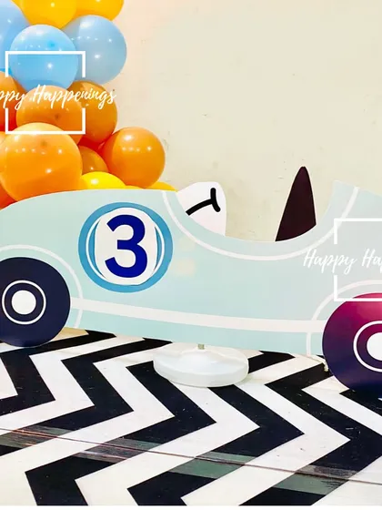 A detailed look at the vintage race car cutout used for the car-themed party. These custom props are perfect for bringing a theme to life and creating fun photo opportunities.