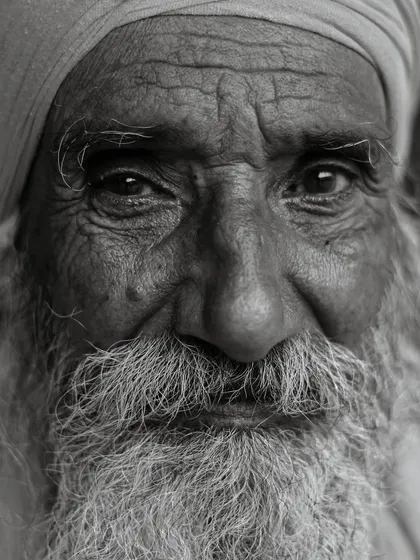 The lines on a person's face tell a lifetime of stories. This intense, close-up black and white portrait was taken to emphasize the texture of his skin and the wisdom in his eyes, proving that the most powerful instrument a photographer has is his own vision.