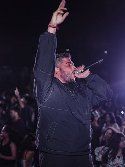 On the mic, commanding the stage at NIFT Mumbai. I use my voice to hype the crowd and guide the party's energy.