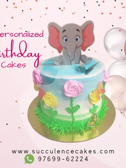 A sweet and gentle elephant-themed cake perfect for a young child's birthday. The soft pastel colors, piped flowers, and adorable elephant topper create a charming and whimsical centerpiece for a special day.