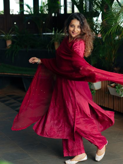A twirling shot to show the beautiful movement and flow of the Heer Muslin Co-ord Set, paired with traditional Rajasthani juttis.