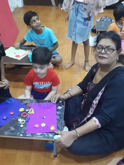 I love sitting down with the students on the floor for a craft session. This informal setup helps them relax and feel more connected.
