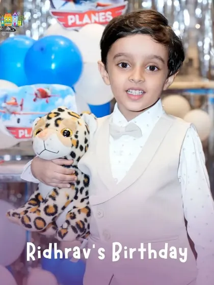 The birthday boy, Ridhrav, looking dapper for his 'Planes' themed party, holding his favorite stuffed animal.