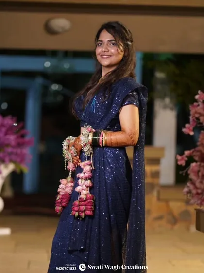 A beautiful portrait of the bride in her sangeet outfit. The floral kalire, made with fresh roses, are the perfect accessory for a night of celebration.