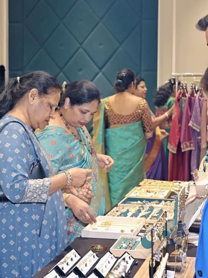 Shopping for jewelry at a pop-up boutique during my Mother's Day event. These curated vendor stalls provide a wonderful activity for guests and enhance the festive, celebratory atmosphere of the day.