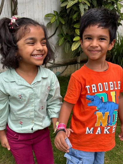 Two friends share a happy moment on Friendship Day. Our children celebrated by crafting and exchanging friendship bands, learning about the importance of companionship and kindness.