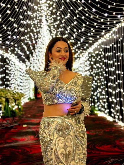 A close-up of my glittery outfit. The feather details on the sleeve added a touch of playful glamour to the look.