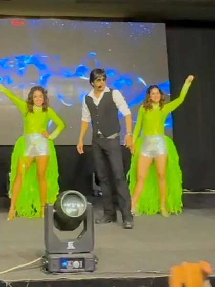 Performing with my dancers in vibrant neon green costumes. We always bring a colorful and visually appealing show.