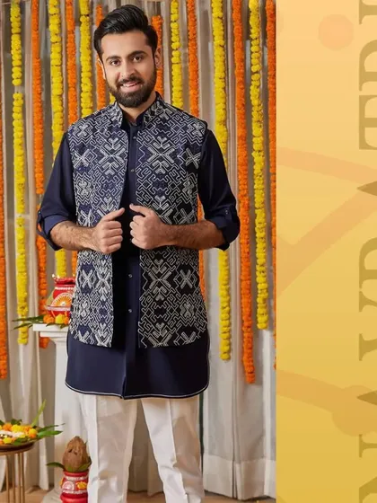 Fuse tradition with a modern twist for Navratri. This navy blue kurta with a geometric print jacket is your key to effortless style, offering both comfort and class.