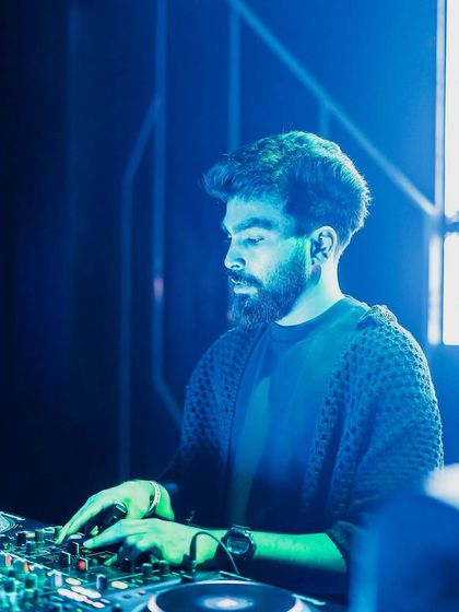 Bathed in the blue and green lights of the club, I'm completely focused on the mix. The lighting and atmosphere are a huge part of the experience.