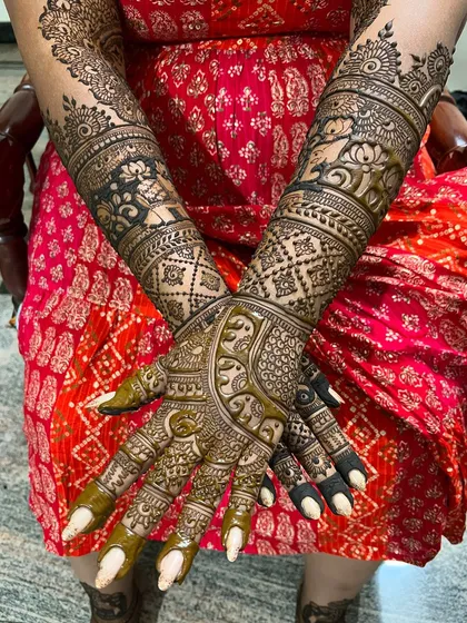 A stunning bridal design with a mix of traditional motifs, including elephants, lotuses, and intricate paisleys.