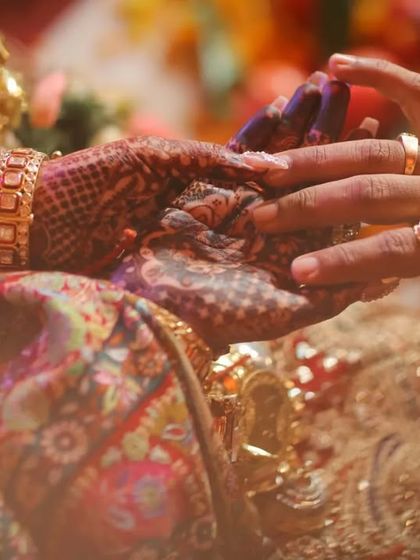 A close up on the hands during a wedding ritual, symbolizing the joining of two lives. We focus on these small but significant details that are full of meaning.