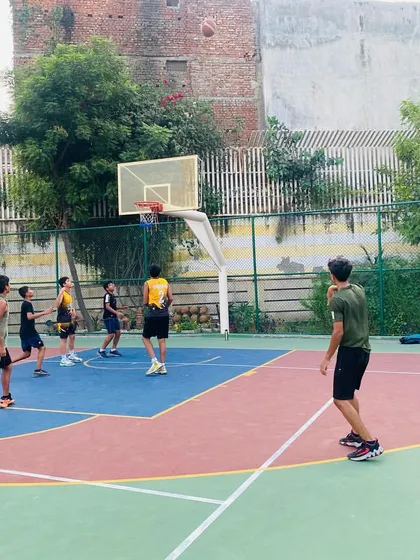 A player shoots a jump shot over a defender.