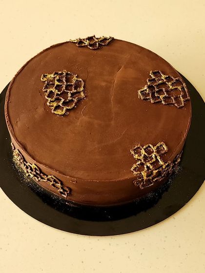 A simpler look for my classic boozy cake. This version focuses purely on the flavor of the Kahlua soaked chocolate sponge and the rich dark chocolate ganache that covers it.